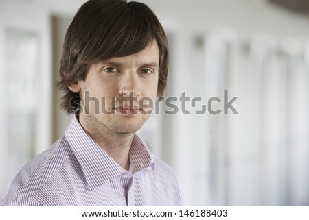 Closeup portrait of a young businessman against blurred background