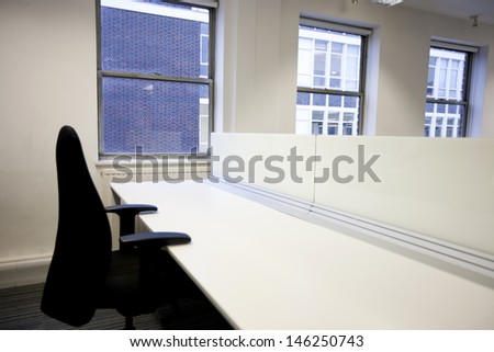 Close up of office chair and empty desk by window