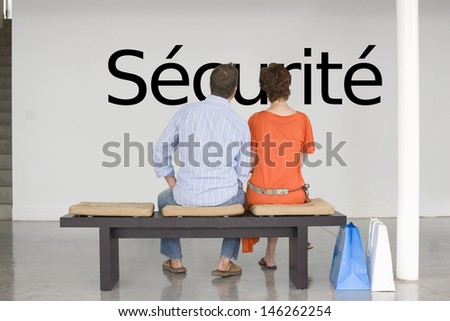 Rear view of couple reading French text 's_curit_' (security) and contemplating about security Photo stock © 