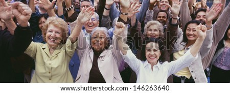 Large group of multi-ethnic people cheering with arms raised