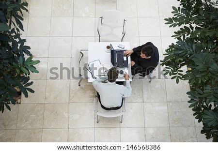 High angle view of businessmen having a discussion at office cafe