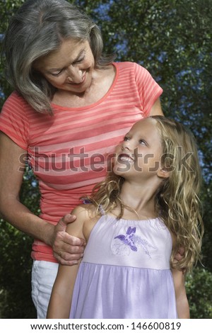 Portrait of a smiling grandmother with girl outdoors