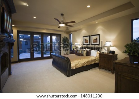 Dark wood furniture in bedroom with ceiling fan