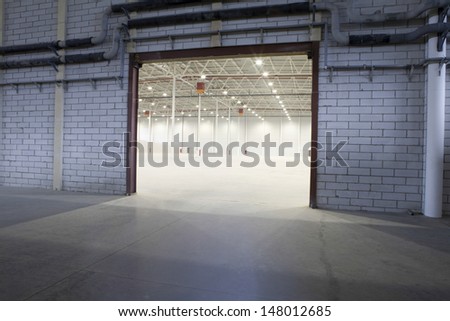 Access door to brightly lit and empty storehouse