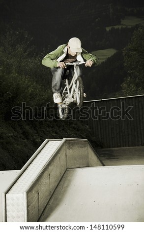 Full length of young man performing stunts on a bike