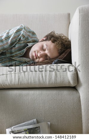 Young man napping on sofa