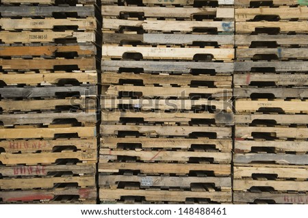 Detail shot of wooden pallets stacked in distribution warehouse