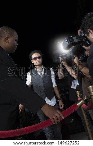 Male celebrity being photographed at media event