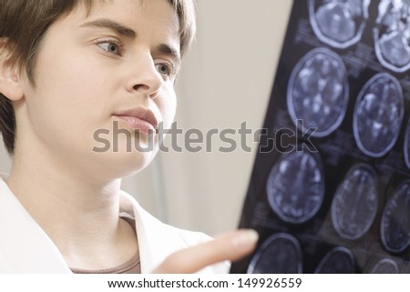 Closeup of a serious female doctor holding CAT scan