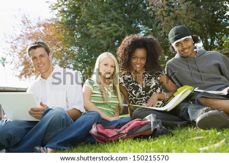 Portrait of multiethnic college friends studying in campus