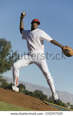 Full length of baseball pitcher throwing ball during game