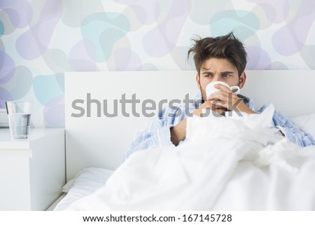 Sick man having coffee in bed