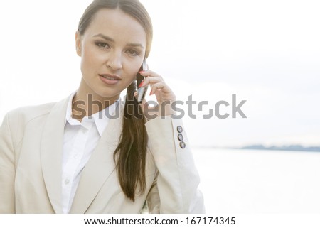 Portrait of confident businesswoman using cell phone outdoors