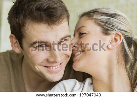 Close-up beautiful young woman kissing man