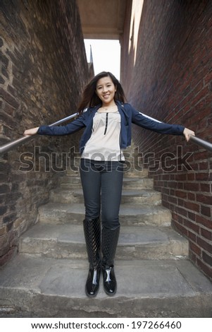 Full length portrait of young woman standing on steps at London; England; UK