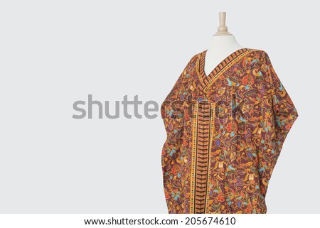 Traditional African dashiki on tailor\'s dummy over gray background
