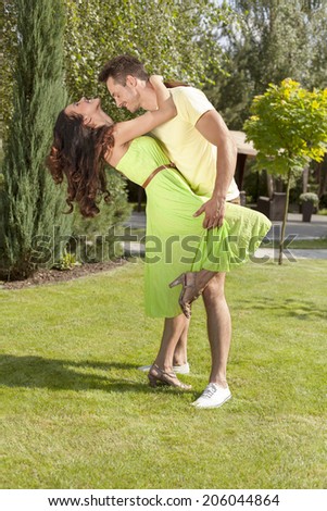 Full length of romantic young couple dancing in park