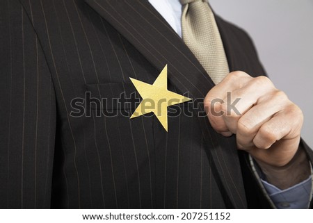 Extreme closeup of a businessman with gold star on suit