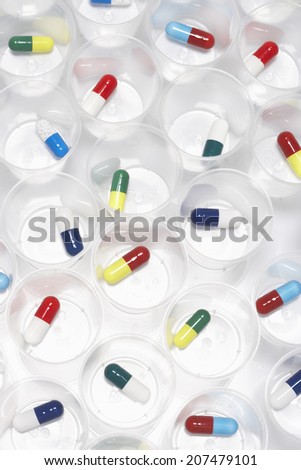 Capsule pills in plastic cups