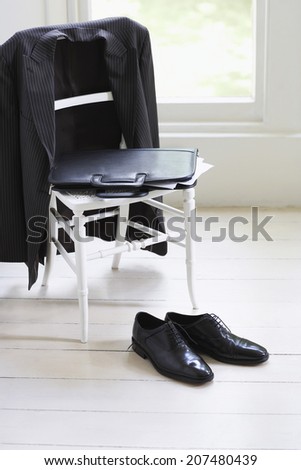 Business suit; case and formal shoes at home