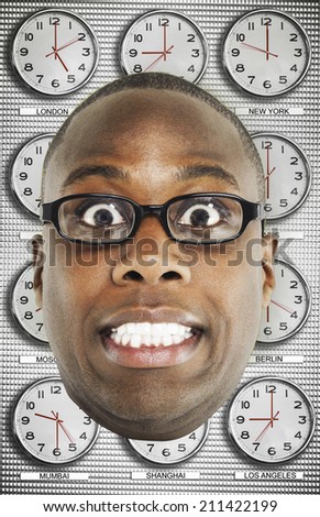 Man with Glasses standing in front of clocks