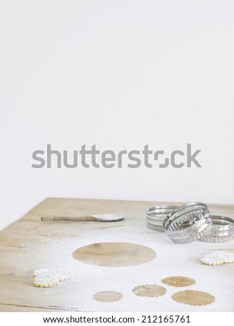 Pastry cutters and flour on table top