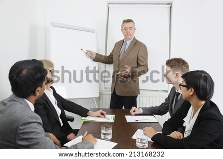 Man using whiteboard in business meeting
