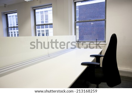 Close up of office chair and empty desk by window