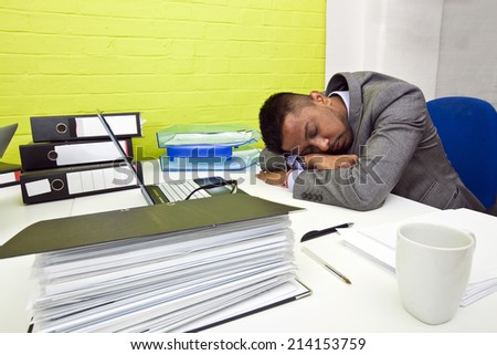 Indian businessman asleep at his desk