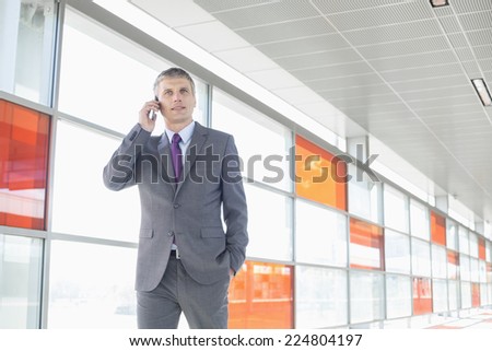 Middle aged businessman using cell phone at train station