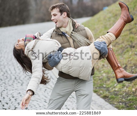 Happy man carrying woman in park