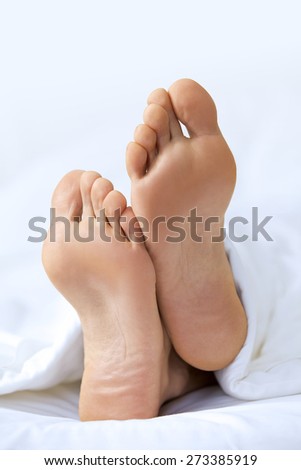 Person\'s foot in bed, close-up