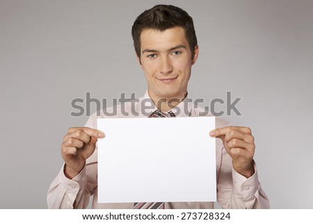 Young happy businessman with good sales results document in his hands