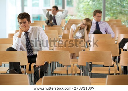 bored Business executives sitting in conference room