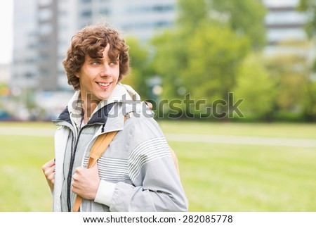 Smiling young male university student at college campus