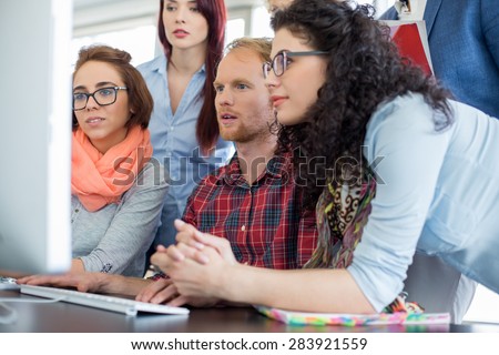 Business people working together on computer in office