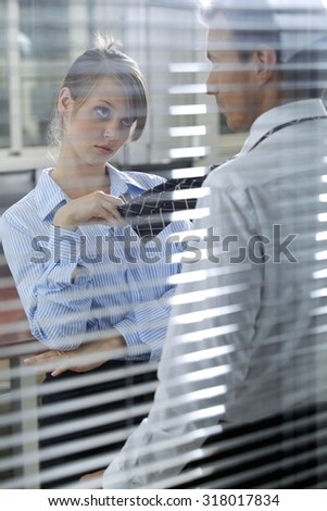 Businesswoman flirting with his colleague in office