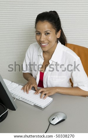 Woman at desk Using Computer, portrait