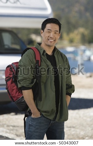Man wearing backpack by RV