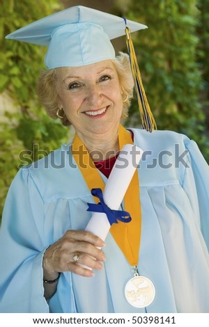 Senior graduate holding diploma outside, portrait