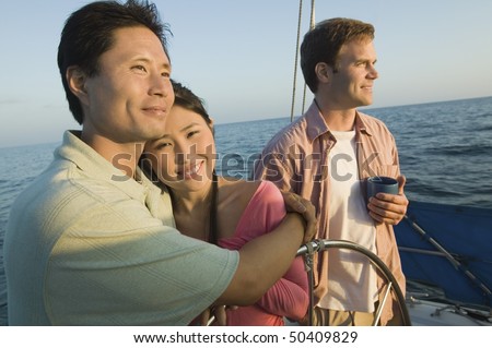 Couple with friend relaxing on yacht