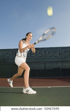 Tennis Player Hitting Backhand on tennis court