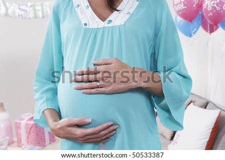 Pregnant Woman with Hands on Her Stomach, mid section