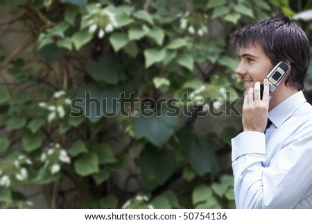 Businessman Talking on Cell  Phone in park garden