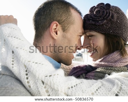 Couple looking in each others eyes, side view, close up
