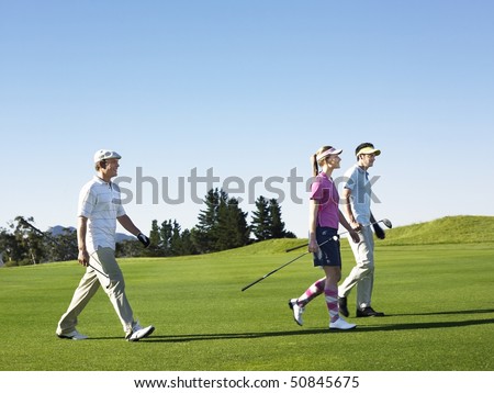 Three young golfers on course
