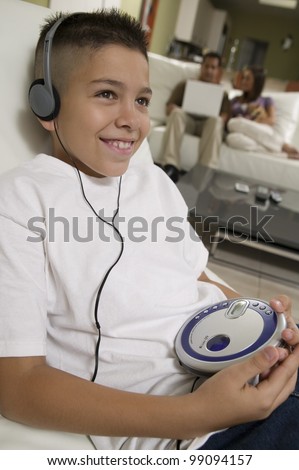 Boy Listening to Music on Portable CD Player