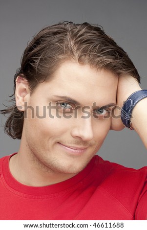 beautiful man in red on a grey background. ?lose up