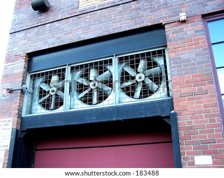 metal turbine fans in a brick building