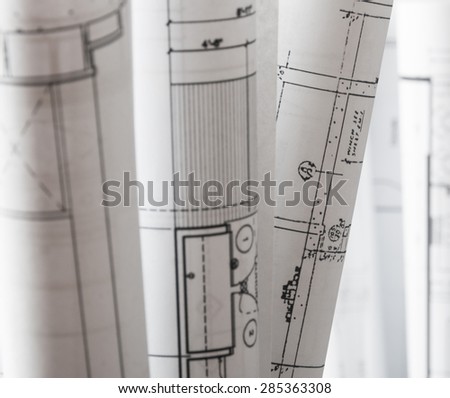 Isolation of several printed rolled drawings for the engineer jobs Project drawings blueprints black background